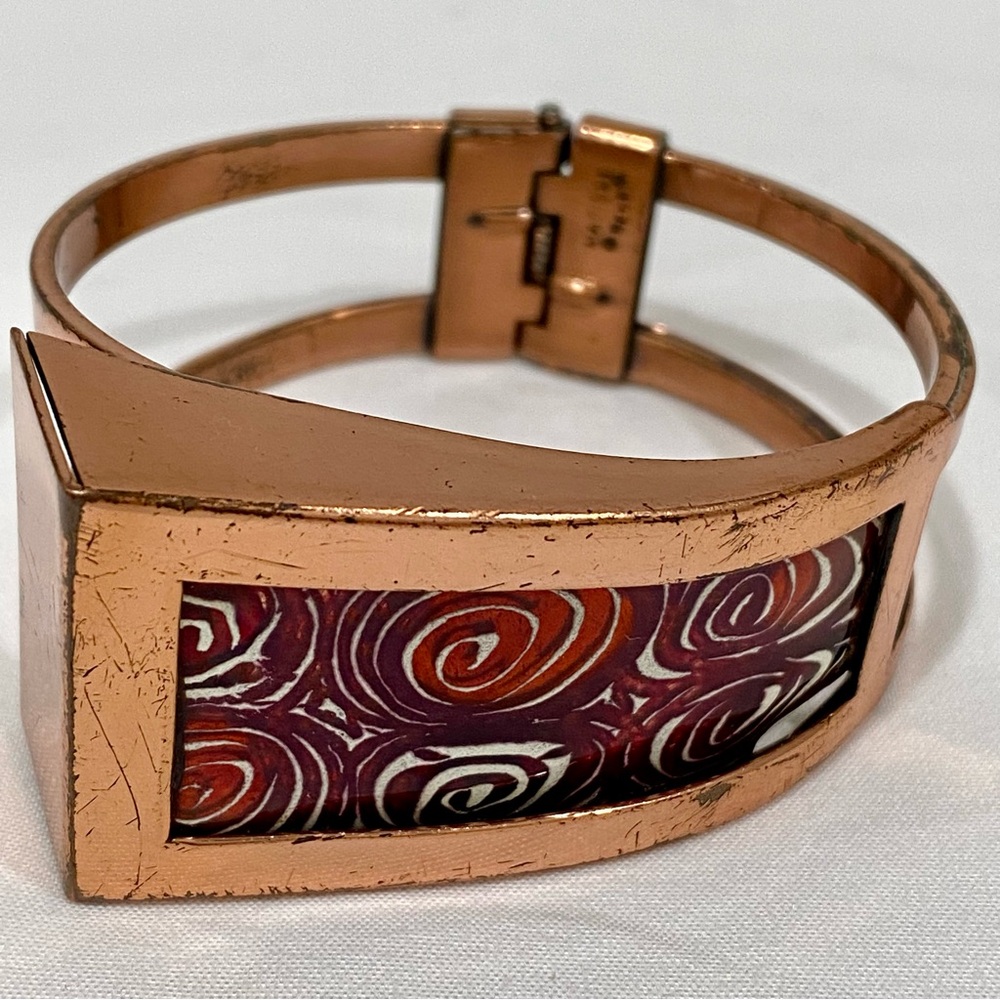Vintage Matisse copper bracelet with a red and white geometric or "atomic swirl"